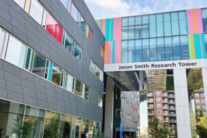 A modern building named "Jason Smith Research Tower"