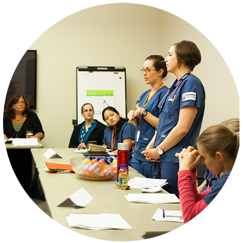 Some nurses are attending a lecture in a classroom setting