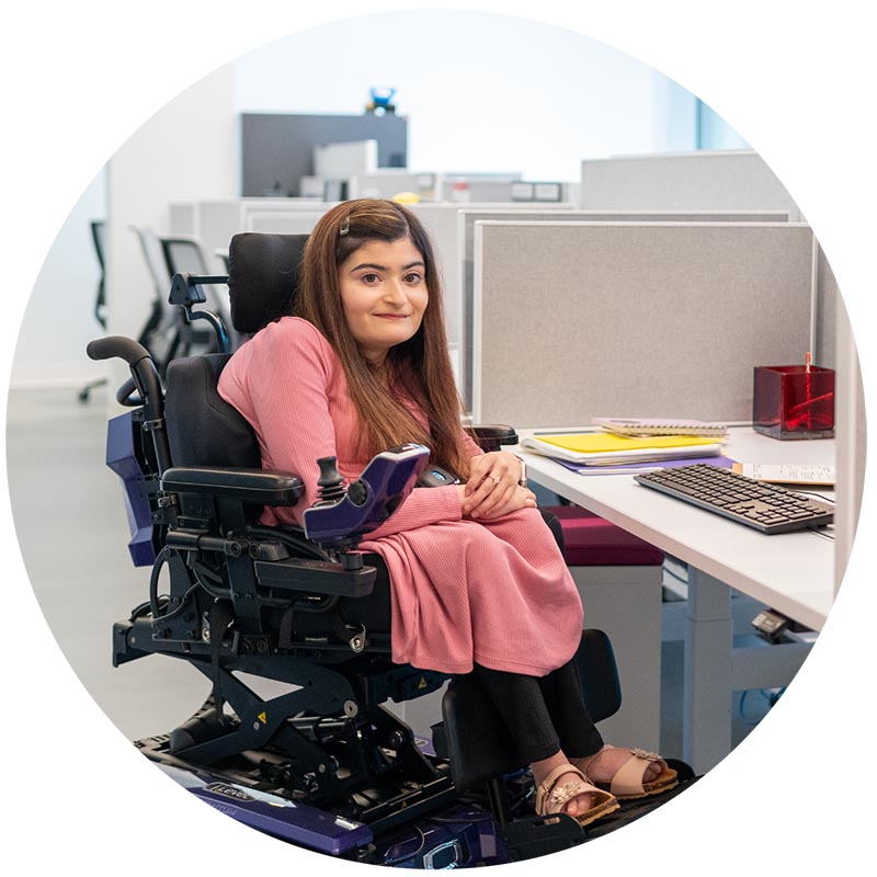 An adult sitting on a electronic wheelchair